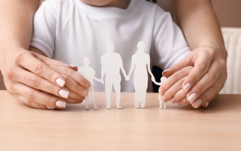 OTS Ondertoezichtstelling kind - Jeugdrecht advocaat nodig? La Causa advocaten Volwassen handen om kinderhanden heen. Samen houden ze een knutsel van hun gezin vast - Jeugdrecht en familierecht samen